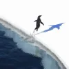 A small Adélie penguin hops on a piece of ice. 