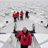 A photo of oceanographer Xavier Pastor aboard an Oceana research vessel surrounded by ice in the Baltic Sea