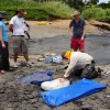 Smithsonian scientists apply a plaster bandage cap to a block of rock containing fossils