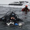 Brian Skerry prepares to dive in icy waters. 