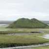 Geologist Charles Paull (Monterey Bay Aquarium Research Institute) investigates geologic features similar to pingos on the Arctic Ocean floor where methane bubbles through sediments and forms hundreds of low hills. On land, a pingo is a place where permafrost bulges beneath a dried lake bed like this one in northern Canada.