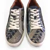 A pair of silver colored sneakers with white shoelaces, made from fish skin and dyed with blue floral patterns.