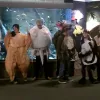 Students in marine life costumes pose in an aquarium.