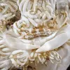 A white crab hides among coral polyps of the same color. 