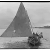 a skin boat with a sail
