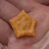 This small sea star, little more than an inch across, is orange on top and whitish underneath.