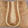 A brown fish skin bag with stitched, organic designs.