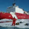 A dive tender monitors divers below the ice.
