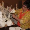 A volunteer puts together the bleached coral reef by stacking pieces of Styrofoam onto wire.