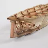 the covering of a skin boat is broken away revealing the frame