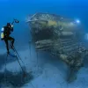 Brian Skerry sits on a 20 foot high underwater tripod to photograph the Aquarius Habitat off Florida.