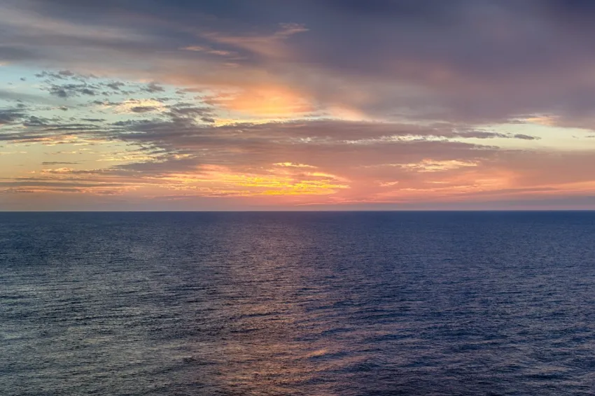 An orange sunset over the ocean.