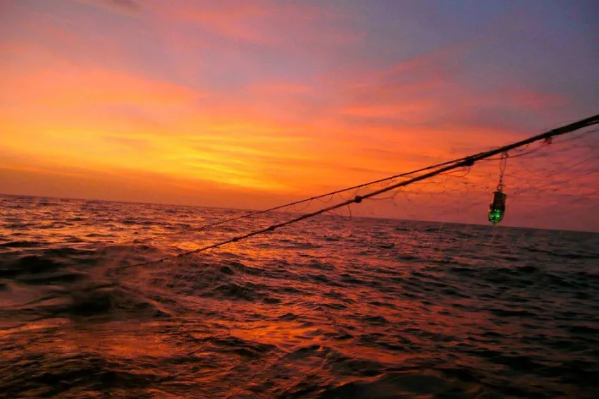 Sunset over a fishing net. 
