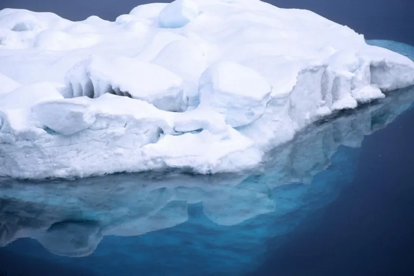 Looking through this iceberg's reflection in the Antarctic water, you can see the iceberg below the surface—some 90% of its total volume. 