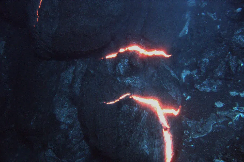 Superheated magma slowly leaks from a crack in the seafloor.