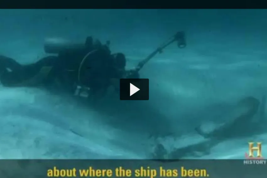 Screenshot from video of a diver swimming with an underwater camera.