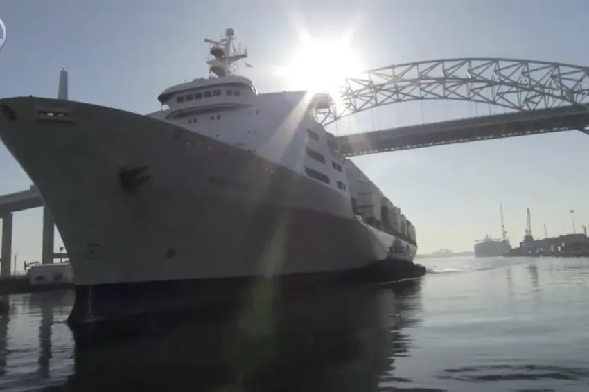 a large ship under a bridge