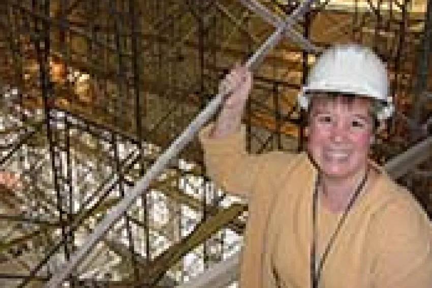 Elizabeth Munsteen wears a hardhat in the Ocean Hall while under construction.