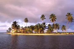 The sun sets over the Smithsonian’s marine field station at Carrie Bow Cay, Belize. For more than three decades, it has been home to the Smithsonian’s Caribbean Coral Reef Ecosystem Program.