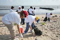 A group of students pick up trash along the coast of Guyana during the Ocean Conservancy's 2012 Coastal Cleanup.