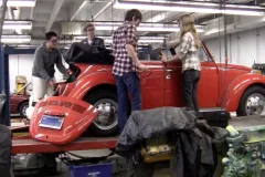 Students studying climate change create an electric car.
