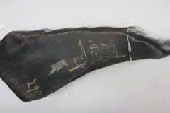 A baleen plate with a drawing of a ship in paint