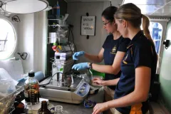 Two women working with testing equipment