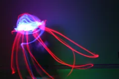 a light painted image of a red and white squid