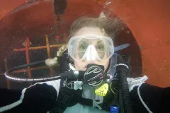 Laurie takes a break collecting invasive species to snap a "selfie" while under the hull of a cargo ship.