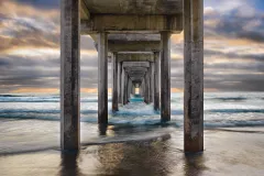 “This composition is a blend of nature and architecture. Shooting beneath the structure to get a unique perspective, I waited for days for a thick mist to lift and reveal the backlighting and color I needed to frame the pier’s converging lines. I was f