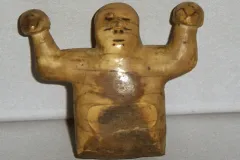 This ivory sculpture from Point Barrow, Alaska, represents Kikámigo, a guardian spirit, holding a whale in each hand.