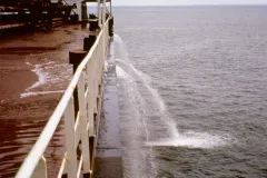 A large ship flushes water from its ballast tanks while at sea