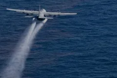 A jet drops dispersant onto the Gulf oil slick.