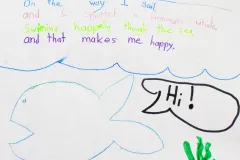 A poem titled "The Whale" written in magic markers with a drawing of a whale. 