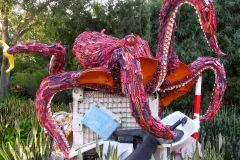 A sculpture of a giant octopus made of ocean debris