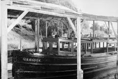 a small boat under a covered dock