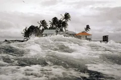 big waves crest near a tropical island 
