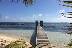 an outhouse at the end of a dock.