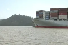 a large ship with shipping containers