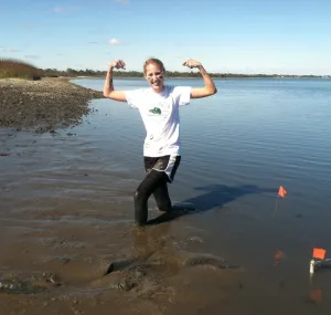 Courtney Gerstenmaier knee deep in water along the coast.