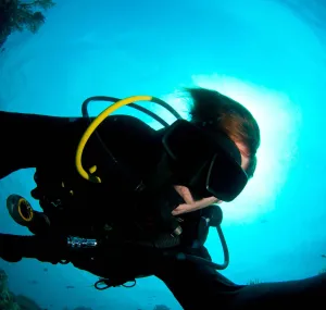 Caine Delacy scuba diving in the ocean.
