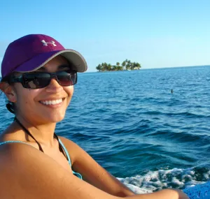 Cristina Castillo smiles at the camera while on a boat on the water.