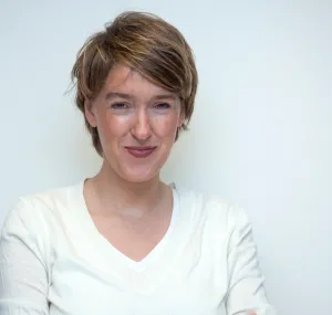 Fanny Douvere smiling in a headshot with a white background.