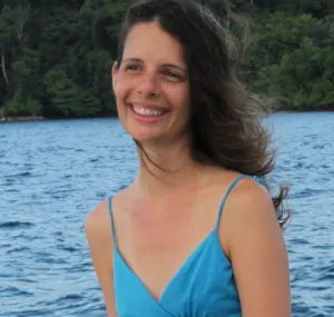 Laetitia Plaisance smiling in a headshot with water behind her.