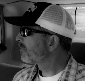 Michael Carl in a black and white image looking away from the camera.