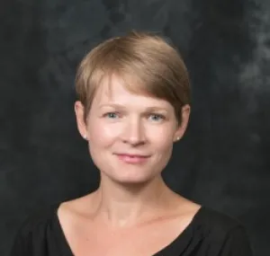 Sam Muka smiling in a headshot.
