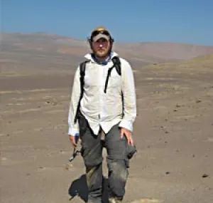 Nicholas D. Pyenson stands with desert in the background.