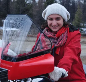 Samia Madwar sitting on a red scooter.