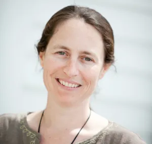A headshot of Lisa Gilbert smiling at the camera.