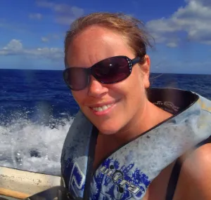 Jennifer Sneed sitting on a boat with a life jacket. 